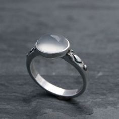 Luminous oval moonstone set in solid sterling silver on a solid sterling silver ring band.Cat eye moonstone gemstone is approximately 3/8" x 1/4" Modern moonstone is a birthstone for June. It's associated with the zodiac sign of Gemini. Moonstone is thought to bring good luck and fortune.This ring will be made to order in your size. Please select your size from the drop down menu.For more rings:https://www.etsy.com/shop/KiraFerrer?ref=hdr_shop_menu&section_id=5254786To see my entire collecti Silver Oval Moon Phase Ring, Silver Oval Ring With Moon Phase, Silver Oval Rings With Moon Phase, Adjustable Oval Cabochon Moonstone Ring, Silver Moon-shaped Sterling Silver Opal Ring, Silver Sterling Silver Moon-shaped Opal Ring, Silver Sterling Silver Moon Shaped Opal Ring, Sterling Silver Oval Rings With Moon Phase, Sterling Silver Oval Rings With Moon Phase Detail