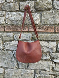 Cognac leather crossbody bag, This bag is a medium size classic crossbody bag. This bag is unlined.  The bag is closed by a magnetic button. This bag you can take every where in any occasion Features : - Cognac leather, - Brass finishing, - Unlined. Size :  - Width 10.2 inch, - Height 8.2 inch, - Adjustable shoulder belt length max 45 inch. If you want to add a boho touch to your bag, buy a suede tassel separately use this link  https://www.etsy.com/it/listing/1524528378/nappina-portachiavi-in-pelle-scamosciata?click_key=7fb2fd2620a322dc68df4e06dd903348ab88127c%3A1524528378&click_sum=bae350f5&ref=hp_opfy-4&frs=1 Contact me for any information                --------------------------------------- The shipping is made after 10 days by the purchase with express courier.                 ----- Cognac Textured Leather Shoulder Satchel, Everyday Textured Leather Crossbody Saddle Bag, Cognac Textured Leather Satchel Shoulder Bag, Textured Leather Saddle Shoulder Bag For Travel, Leather Saddle Flap Bag For Everyday Use, Everyday Use Saddle Flap Bag With Adjustable Strap, Classic Brown Crossbody Hobo Bag, Cognac Soft Leather Crossbody Hobo Bag, Soft Leather Saddle Bag For Everyday Use