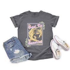 Looking for a cute versatile top to wear? Make sure to grab one of our Graphic tees! This soft and comfortable graphic tee is the perfect top for any outfit. It can be paired with biker shorts, jeans, or even a simple skirt/dress! This tee is true-to-size, so be sure to order your regular t-shirt size! If you are looking for a more oversized look, make sure to size up! Trendy Relaxed Fit Faded T-shirt, Spring Washed Black T-shirt With Letter Print, Acid Wash Slogan Top With Relaxed Fit, Acid Wash Relaxed Fit Slogan Top, Trendy Tie Dye Washed T-shirt, Relaxed Fit Acid Wash Top With Slogan, Relaxed Fit Acid Wash Slogan Top, Acid Wash Cotton Top With Slogan, Acid Wash Cotton Slogan Top