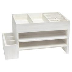 a white wooden shelf with two compartments on each side and one drawer at the top