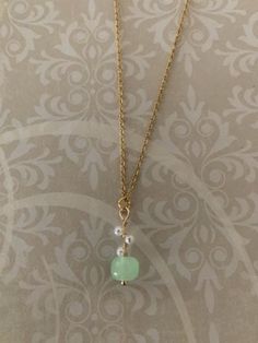 "Lovely, sweet and dainty gold tone, hetian jade bead and simulated seed pearls necklace, hetian jade necklace, mint green necklace, mint necklace, hetian jade pendant, green and pearl, green Pendant measures 7/8\" L X 5/16\" W and is on an 18\" chain." Green Beaded Necklace With Pearl Drop For Gift, Green Pearl Drop Necklace Gift, Green Pearl Drop Necklace For Gift, Green Pearl Chain Jewelry As A Gift, Delicate Green Charm Necklaces With Delicate Chain, Green Pearl Necklace As A Gift, Green Pearl Necklace For Gifting, Delicate Green Necklace With May Birthstone, Delicate Green May Birthstone Necklace