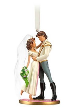 a bride and groom figurine holding each other