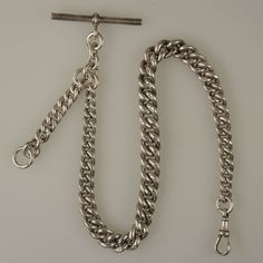 This English silver pocket watch chain has clear hallmarks for Birmingham 1900 The chain is made up of a single length of graduated curb links which are larger than usual The chain weighs 61g The watch measures 300mm from the T Bar to the dog clip and is 9.6mm at the widest point. There is an additional length of chain from which to hang a fob or accessory. The chain is in 100% mint condition Silver Pocket Watch, Pocket Watch Chain, Dog Clip, Watch Chain, Silver Watch, The Dog, Pocket Watch, Birmingham, Mint Condition