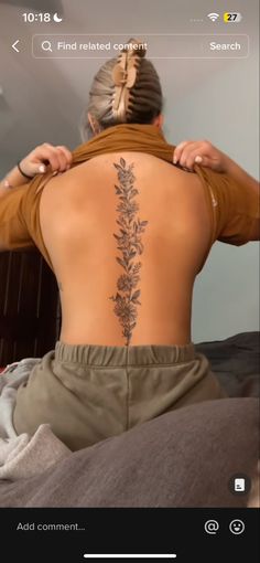 a woman with a flower tattoo on her back