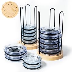 three glass jars with metal holders on wooden bases, each containing one cell phone and the other two