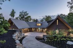 a large house with a walkway leading to it's front door and entry way