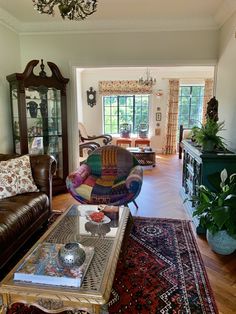 a living room filled with furniture and lots of windows