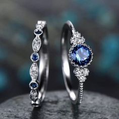 two silver rings with blue and white stones