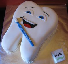 a birthday cake with a toothbrush and dental floss