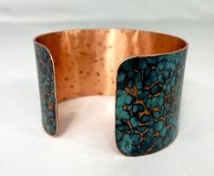 These unique, hand-formed copper and brass cuff bracelets with vibrant patinas create stunning accents to your personal style. Dress up or down- either way you'll be wearing an adornment that will turn heads, start conversations, and delight the eye of the beholder. This is a hammered copper cuff with a bright blue cupric nitrate patina. Please note that patina colors look slightly different depending on the device you view the product on. This is a Large size cuff- see measurements below. Cuffs Artisan Copper Bangle Cuff Bracelet, Artisan Copper Cuff Bangle Bracelet, Unique Hammered Copper Cuff Bracelet, Artisan Electroformed Cuff Bangle Bracelet, Artisan Bronze Copper Cuff Bracelet, Hand Forged Bronze Copper Cuff Bracelet, Adjustable Patina Bangle As Gift, Artisan Bronze Bracelets With Patina, Artisan Adjustable Cuff Bracelet With Patina