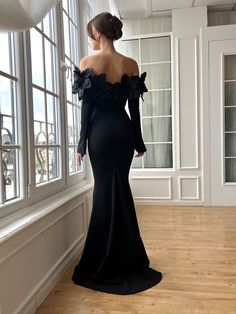 This elegant black off-shoulder dress features bold floral details and smooth Lycra fabric. The fitted bodice with boning and long sleeves highlight the figure, while the slim pencil design adds a polished touch. With a zipper back, it’s a great choice for formal events, galas, or special occasions.