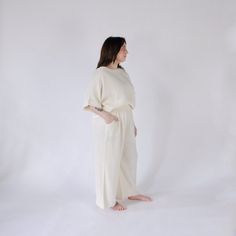 This is loungewear without limits. Comfortable and classy - this one-sized boat top is ideal for those looking to feel luxurious at home, on the town, with glam or on the go. Made with a luxe fabric composed of doubled Turkish muslin cotton. The crinkle muslin texture is incredibly soft on the skin, and feels lightweight, yet substantial when worn. Designed in an oversized style, the Crinkle Crop Top has half sleeves, with a cropped cut at the waist, and a boat neckline. Available in two color s Cream Linen Tops For Loungewear, Cream Linen Loungewear Tops, Beige Cotton Top For Lounging, Beige Cotton Lounging Top, Spa Trip, Slouchy Pants, Pom Pom Pillows, Upcycled Bag, Animal Blanket