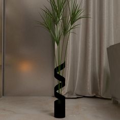 a tall black vase with a plant in it