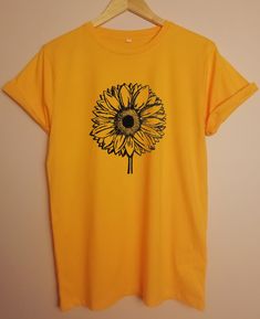 Sunflower ORGANIC tshirt JOIN OUR GREEN REVOLUTION - FASHION DOES NOT HAVE TO POLLUTE THE PLANET *RUNS LARGE - SEE SIZE GUIDE *CLIMATE NEUTRAL MANUFACTURING *SUPER SOFT ORGANIC COTTON *SWEATSHOP FREE - FAIR WAGE FOR WORKERS *MANUFACTURED USING GREEN ENERGY *PRINTED TO ORDER USING WATERBASED INKS AND LOW IMPACT METHODS *1-5 BUSINESS DAYS PROCESSING *30 DAYS RETURNS/EXCHANGES   *Fair Wear Foundation  *FWF *Global Organic Textile Standard (GOTS) *PeTA-approved * Vegan Hand printed to order using extremely low impact methods and eco friendly, solvent free waterbased inks Soft, luxurious feel 1-5 business days processing time Sustainable, ethical and socially responsible manufacturing  Shipped in Paper bags 30 day return/exchange policy Wash at 30 degrees Yellow T-shirt With Sunflower Design For Spring, Cotton Crew Neck T-shirt With Sunflower Design, Yellow T-shirt With Plant Print For Summer, Yellow Plants Print Short Sleeve T-shirt, Yellow Short Sleeve T-shirt With Plant Print, Summer Sunflower Design Short Sleeve T-shirt, Yellow Sunflower T-shirt For Spring, Yellow Sunflower Design T-shirt For Spring, Yellow Sunflower Print Graphic Tee