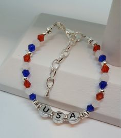 "USA Bracelet This darling USA bracelet is fun conversation jewelry and would make perfect festival jewelry. Trendy Jewelry is both fun jewelry and makes great gifts for her. Holiday bracelets help make the day special and this piece is a sweet reminder that Americana gifts are great way to show American Pride. Bracelet is 6 1/2\" with a 1 1/2\" extension. The stamped silver colored beads are double sided. This listing is for the Bracelet ONLY Hypoallergenic to eliminate irritation/ Excellent cu Nickel Free Stretch Bracelet Gift, Cute Nickel-free Friendship Bracelets, Friendship Bracelets For Mother's Day, Adjustable Bracelets With Lobster Clasp For Birthday, Adjustable Bracelet With Lobster Clasp For Birthday, Adjustable Bracelet With Lobster Clasp For Birthday Gift, Cute Nickel-free Bracelets For Birthday, Nickel-free White Bracelets For Birthday, Cute Nickel-free White Bracelets