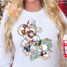 a woman wearing a white shirt with cartoon characters on it