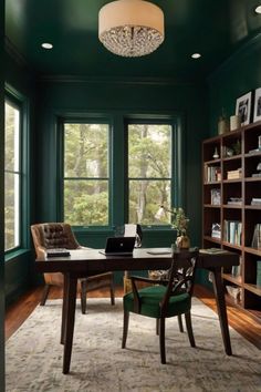 a home office with green walls and wood flooring, built in bookshelves