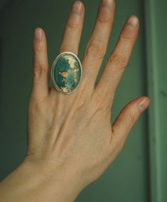 *Ready to ship* Size 9 Moss agate set in fine silver and Merlin's gold jeweler's brass. The beautiful flowing pattern within the stone can be seen better in the close ups which feature a separate maple leaf ring resting on top...it is not included but is available in a another listing. I used fine silver serrated bezel for this design without any patina. I wanted to keep it light all over. It has a brass brushed satin finish. Which you can still see reflection in just not as mirror reflective as Flowing Pattern, Werewolf Mask, Bat Mask, Moss Agate Ring, Leather Hats, Leaf Ring, Agate Ring, Little Red Riding Hood, Hat Band