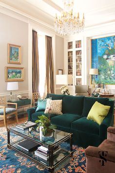 a living room filled with furniture and a chandelier