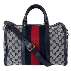 100% authentic Gucci Vinatge Boston bag in navy blue and ivory GG canvas with blue leather trim and classic red & blue Web stripe in the middle. The design features light gold-toned hardware and opens with a zipper on top. Lined in ivory canvas including one zip pocket and two smartphone pockets.Has been carried and shows one darker spot on the lining. Two extra holes got added tot the shoulder-strap. Overall in excellent condition. Comes with dust bag. Measurements Height 21cm (8.2in) Width 32c Bag Measurements, Boston Bag, Blue Suede, Blue Bags, Leather Trim, Blue Leather, Fashion Handbags, Gucci Bag, Red Blue