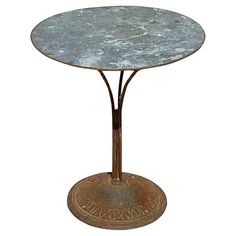 a round metal table with an iron base