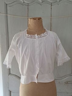 Antique french fine cotton chemise with pleat and lace detail, milk glass buttons. In very good antique condition. one tiny hole, see picture. Measures Bust 40" 102cm Shoulder to hem 18" 46cm Arm hole diameter 8" 20cm 74g Victorian Cotton Top With Lace Trim, Victorian Cotton Tops With Lace Trim, Victorian Cotton Blouse With Lace Collar, Victorian Lace Trim Top For Daywear, Victorian Cotton Tops For Summer, Victorian Style Tops For Summer Daywear, Victorian Tops For Summer Daywear, Cotton Cottagecore Blouse For Daywear, Vintage Broderie Anglaise Blouse For Daywear