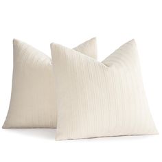 two white pillows sitting next to each other