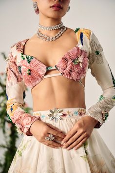 Beach wedding coming up? We’ve got you covered! Choose this stunning pastel floral lehenga paired with a chic blouse featuring full sleeves and a cutout design. The florals are beautifully highlighted with beadwork, and the set includes a matching dupatta. Multicolor Floral Print Choli For Party, Multicolor Floral Print Party Choli, Elegant Floral Print Sharara For Spring, Floral Print Sets For Festive Party Occasions, Festive Floral Print Party Sets, Bollywood Floral Print Sets For Party, Summer Reception Choli With Floral Print, Summer Floral Print Choli For Reception, Summer Reception Floral Print Choli