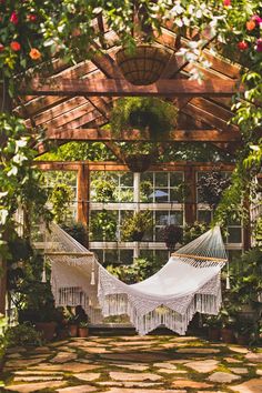 a white hammock hanging from a wooden structure