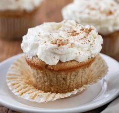 cupcakes with white frosting and cinnamon sprinkles on a plate