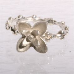 This is the most delicate and beautiful ring, its cast in solid sterling silver and the flower comes in 2 options, with the leaves squared shaped or in a diamond shape. please make sure to specify your preference. the band is a delicate multi ball shank. the ring is size 7 but can be custom ordered in what ever size you need.  all items ship in a gift box all items are made in a smoke free home please contact me if you have any questions or requests Flower Silver Ring, Delicate Sterling Silver Flower Ring, Delicate Silver Ring With Flower Shape, Silver Delicate Flower Shaped Ring, Delicate Silver Flower-shaped Ring, Delicate Sterling Silver Flower Shaped Ring, Delicate Adjustable Silver Flower Ring, Minimalist Sterling Silver Flower-shaped Ring, Silver Stackable Flower Ring