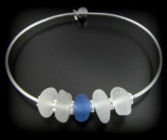 a bracelet with four sea glass pieces on it