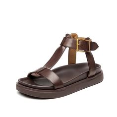 The Sara T-strap leather sandals for women from USS Shoes are made with genuine cow leather and lined with soft sheepskin, these sandals provide superior quality. Featuring a back strap and an open side vamp, these sandals have a secure fit with a buckle strap closure. Available in black and brown, perfect for casual o Leather T-strap Sandals, Brown Leather T-strap Sandals, Brown Leather Footbed T-strap Sandals, Brown T-strap Sandals With Leather Lining, Brown T-strap Sandals With Leather Sole, Leather T-strap Sandals With Round Toe And Tang Buckle, Spring T-strap Sandals With Tang Buckle, Brown T-strap Sandals With Tang Buckle And Round Toe, Leather T-strap Slingback Sandals