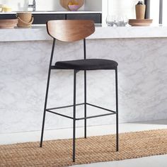 a bar stool sitting on top of a rug in front of a kitchen countertop