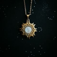 "Bring out your inner Moon witch and lunar Goddess and celebrate the feminine connection between us and our Moon. A beautiful brass pendant with a halo of crescent moons, set with a flashy piece of rainbow Moonstone. This necklace celebrates the mystery and majesty of our closest cosmic dance partner. A wonderful new age gift for the astrology lover or modern witch. Pendant Size: 1 1/2\" x 1\" (4.7cm x 3.2cm) Chain Length: 18\" (46cm) Materials: brass, rainbow moonstone Please remember - this pi Celestial Crescent Moon Phase Necklace, Celestial Moon-shaped Jewelry For Meditation, Celestial Moon Jewelry For Meditation, Celestial Round Necklace For Meditation, Celestial Style Necklace With Moon Charm, Celestial Crescent Jewelry For Meditation, Brass Moon Charm Jewelry, Spiritual Moon Charm Pendant Jewelry, Celestial Round Pendant Necklace For Healing