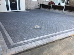 a block paved driveway in front of a house