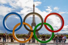 the olympic rings in front of the eiffel tower