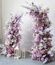 two archways with flowers and lanterns on the floor