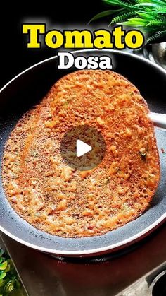 a pan with some food in it on top of a table and the words tomato dosa