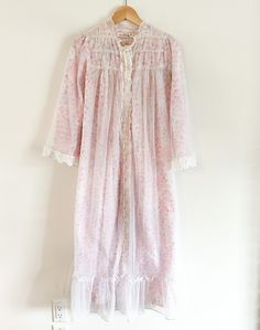 Vintage Brody pink floral duster/ night robe. - Sheer overlay with ruffled neckline and hemline - Embroidered lace detailing  - Snap Closure - Size Medium In Perfect vintage condition with no defects to note. MEASURMENTS: (Taken while the garment is laying flat)  Shoulders: 13" Sleeves: 20" Bust: 19" Waist: 22" Hips: 25" Length: 48" Floral Duster, Ruffled Neckline, Sheer Overlay, Pajama Robe, Womens Robes, Vintage Rose, Embroidered Lace, Vintage Pink, Night Gown