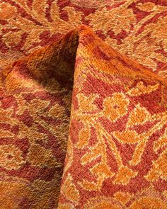 an orange, red and yellow patterned rug