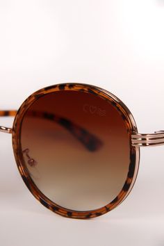 Introducing our Oval Ombre Tortoise sunglasses, where timeless design meets modern allure. These exquisite eyewear pieces are the embodiment of elegance, featuring distinctive tortoise frames that effortlessly merge classic aesthetics with contemporary fashion. The oval shape of the frames exudes an air of sophistication and versatility, making them an ideal choice for those who appreciate understated luxury. Crafted with meticulous attention to detail, the tortoise frames showcase a captivating Elegant Brown Sunglasses With Round Frame, Elegant Brown Round Frame Sunglasses, Tortoiseshell Sunglasses With Tinted Lenses And Round Frame, Tortoiseshell Round Frame Sunglasses With Tinted Lenses, Tortoiseshell Sunglasses With Tinted Round Frame, Tortoiseshell Sunglasses With Tinted Round Lenses, Chic Brown Round Frame Sunglasses, Tortoiseshell Sunglasses With Gradient Round Frame, Elegant Brown Aviator Sunglasses With Uv Protection