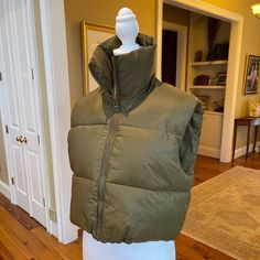 Nwt- Never Worn! Womens Cropped Puffer Vest, High Stand Collar, Front Full Zip, Adjustable Drawstring Hem, Cropped Length, Solid Color, Fashion Sleeveless, Lightweight Warm Puffer Gilet. Army Green Sz M Measurements: Length - 18.5 Inches From Top Of Shoulder To Bottom Hemline 20 Inches From Armpit To Armpit Sleeveless Puffer Vest For Cold Weather, Solid Puffer Sleeveless Vest, Khaki Sleeveless Winter Vest, Fitted Puffer Vest For Cold Weather, Fitted Khaki Vest For Winter, Sleeveless Cotton Puffer Outerwear, Cotton Puffer Vest, Winter Khaki Vest, Cropped Puffer Vest