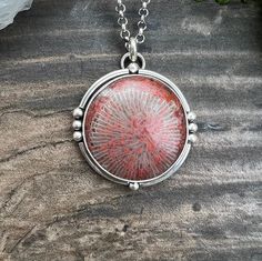 Gorgeous Red Horn coral from Utah set in sterling and fine silver on an 18" sterling chain.  Pendant measures approximately 1 5/16" diameter. Elegant Round Coral Necklace, Elegant Coral Round Necklace, Red Sterling Silver Jewelry With Polished Finish, Coral Oval Jewelry For Gifts, Oval Coral Jewelry For Gift, Elegant Coral Sterling Silver Jewelry, Unique Necklace With Sterling Silver Clasp, Unique Necklaces With Sterling Silver Clasp, Unique Round White Gold Necklaces