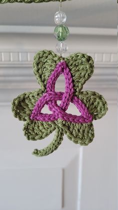 a crocheted flower hanging from a ceiling