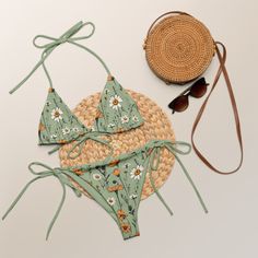 A sage green triangle bikini set with meadow flowers and sage green lining channels bohemian vibes. This bikini comes in sizes up to 6XL. It's made from recycled material. It can be tied in multiple ways. Flattering fit and pattern make a perfect addition to your swimwear collection. Please check the sizing chart between the listing photos. In case of any questions feel free to message me. Item is custom-made per order. The bikini was designed by me and it's made by Printful in their production Bohemian Tie-side Bottom Swimwear For Spring, Green Tropical Tie-side Swimwear, Tropical Green Tie-side Swimwear Bottom, Tropical Green Tie-side Swimwear, Green Tie-side Bottom Swimwear For Beach, Green Beachwear Swimwear For Festival, Bohemian Green Tie-side Swimwear Bottom, Green Festival Beachwear Swimwear, Green Swimwear For Sunbathing On Vacation