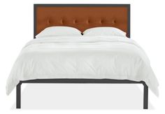 a bed with a brown headboard and white sheets on it's side, in front of a white background