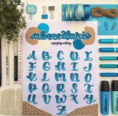 an assortment of crafting supplies including pens, markers and paper with writing on them