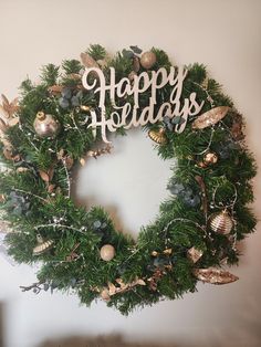 a christmas wreath with the words happy holidays on it