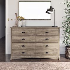 a wooden dresser with a mirror on top of it